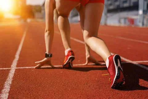 Running shoe of athletic runner training in stadium at sunset, preparing fo.. Stock Photos