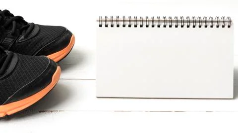 Running shoes and notepad Stock Photos