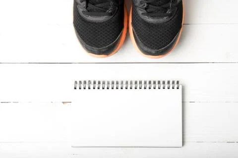 Running shoes and notepad Stock Photos
