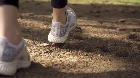 Running Shoes Close-Up as They Walk Through Park Stock Footage