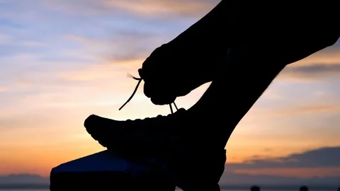 Running shoes - Man is tying shoe laces. male sport fitness runner getting re Stock Footage