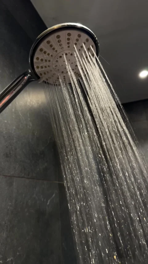 Running shower water from chrome showerhead, plumbing installation, bathroom rep Stock Footage 345003005