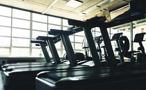 Running simulators in the gym interior. Empty fitness rooms without people Stock Photos