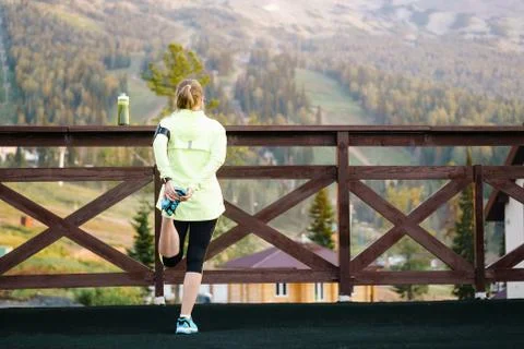 Running stretching runner doing warm-up before the marathon. Stock Photos