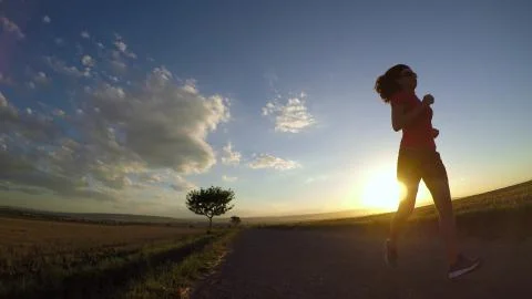 Running at sunset. Stock Photos