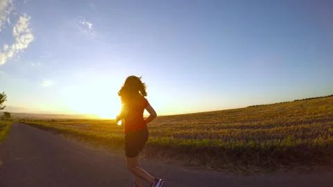 Running at sunset. Stock Photos