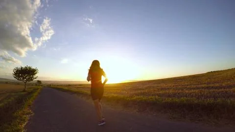 Running at sunset. Stock Photos