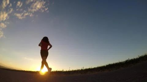 Running at sunset. Stock Photos