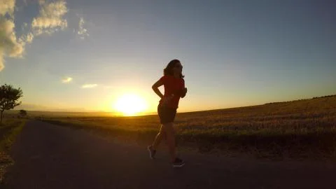 Running at sunset. Stock Photos