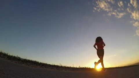 Running at sunset. Stock Photos