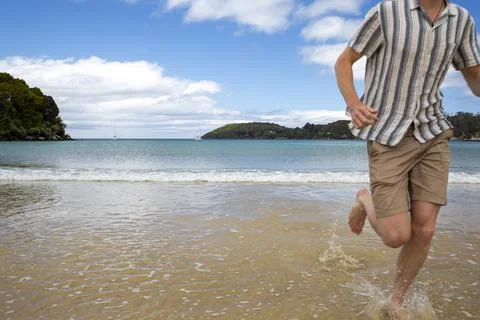 Running in the surf on the beach 스톡 사진
