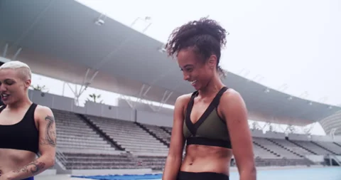 Running, teamwork or athlete with hug on track, commitment or fitness training Stock Footage 256967336