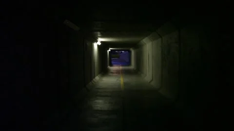 Running through a Dark Cement Tunnel Stock Footage