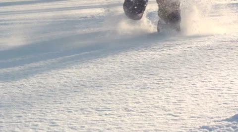 Running through the deep fresh snow on a sunny frosty day. Close up of feet. Stock Footage 46794460