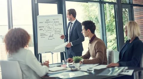Running through their sequence of steps to success. a businessman giving a Stock Photos