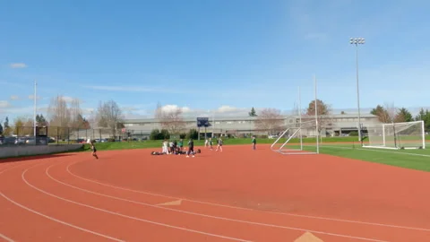 Running track and athletic field at a school sports facility in Milton  garden 1 Stock Footage 340307775