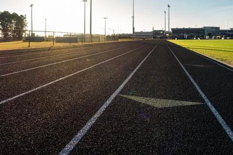 Running Track Sun Flare Arrow Lanes Black Turf Grassy Sports Field Stock Photos