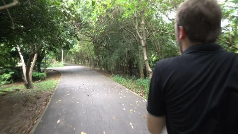 Running Tracking Shot - Jogging in Park Stock Footage 100219553