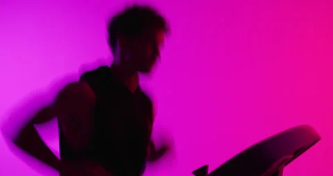 Running, treadmill and man in studio, exercise and cardio workout on pink Vidéo 331068020