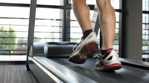 Running on treadmill, close up of feet, workout training in fitness centre Stock Footage 89930092