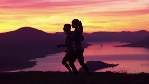 Running - two women runner jogging at sunset. Video stock 82561606