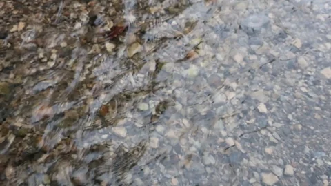 Running water drains into a stream Stock Footage 128933105