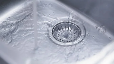 Running water flowing into the kitchen sink Stock Footage 336234740