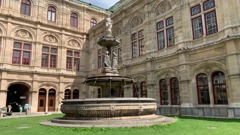 Running water fountain at tiny square near Vienna State Opera building. Austria Stock Footage 205934503