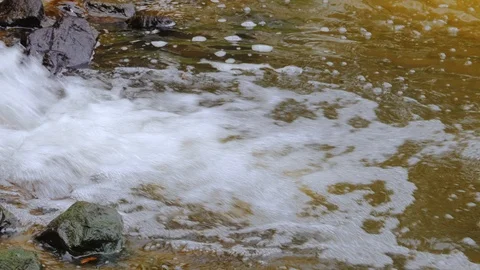 Running of water stream from waterfall on rocks from the sewer, river pollution Stockbeeldmateriaal 108488833