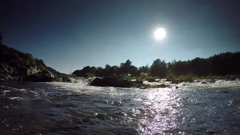 Running waters of river looking into sun Stock Footage 153216398