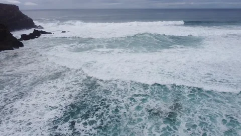 Running from the Waves of the ocean. Drone shot Video stock 143496429