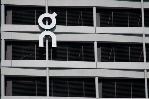 On Running white logo close up on modern headquarter building facade in Zuric Stock Photos