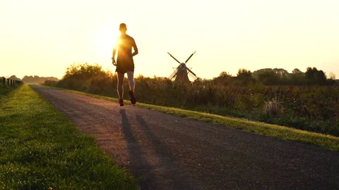 Running at a windmill Stock Footage 132049590