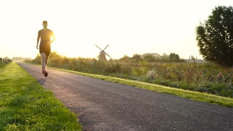 Running at a windmill Stock Footage 134609606