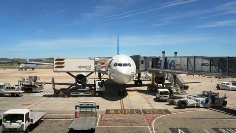 Runway with plane with loading dock in Madrid's airport Stock Footage 116056737