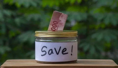 Rupiah Money in Saving Jar with Save Label. Saving Concept Stock Photos