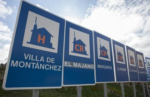 Rural accomodation sign posts placed at village entrance Stock Photos