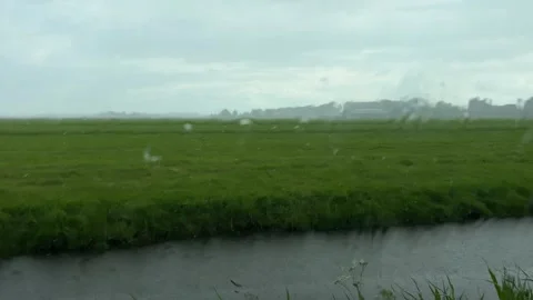 Rural Amsterdam, Rain-speckled window over rural Amsterdam fields under Stock-Footage 342749635