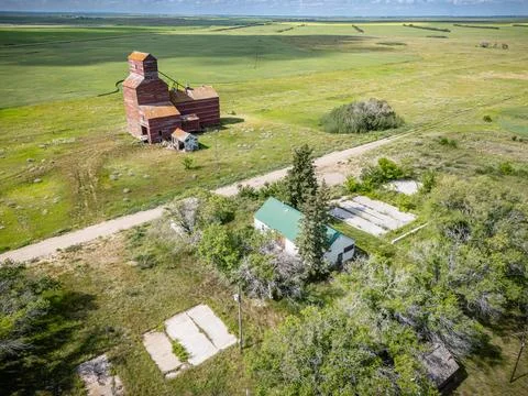 Rural area with a large grain elevator and a small house Stock Photos