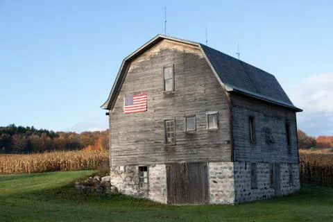 Rural barn with US flag on it Stock Photos