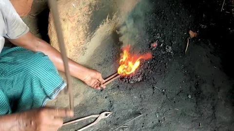 Rural blacksmith workshop scene with fire, tongs, and metalworking tools Stock Footage 330412393