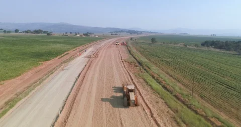 Rural construction of road through fields in third world setting aerial 4K Stock Footage 85956429