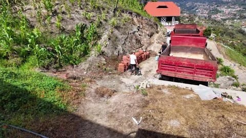 Rural Construction Site with Red Cargo Truck and Bricks in Mountain Landscape Видео 333417844