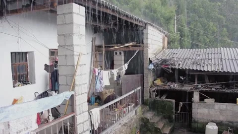 Rural courtyard in the rain Stock Footage 234493856