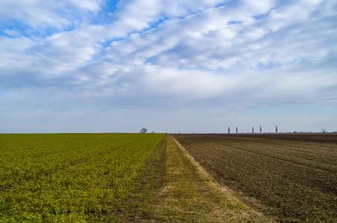 Rural Divide Under a Cloudy Sky Stock Photos