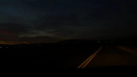 Rural driving during dusk with amazing sunset in distance. Stock Footage 90017543