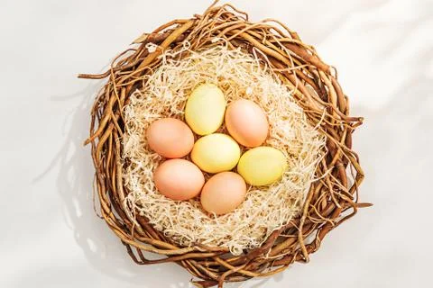 Rural Easter composition with colorful eggs in nest Stock Photos