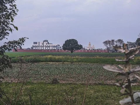 Rural field with distant building and temple Stock Photos