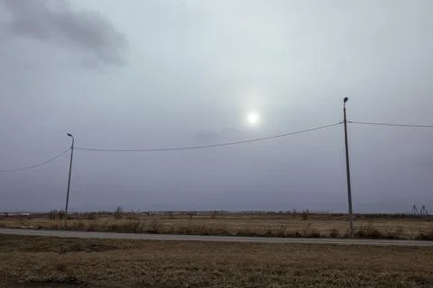 Rural field landscape with lighting pillars along the road. Stock Photos