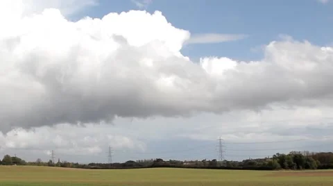 Rural green fields, big cloudy blue sky and overhead electricity pylons 스톡 동영상 42506429